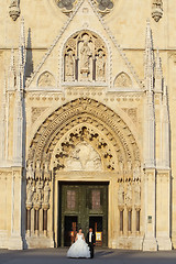 Image showing Newlyweds standing in front of Cathedral