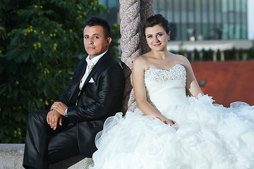 Image showing Newlyweds posing next to pillar