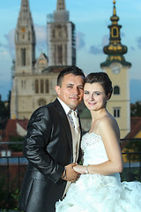 Image showing Bride and groom holding hands