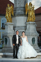 Image showing Newlyweds standing in front of fountain