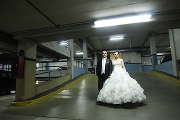 Image showing Newlyweds standing in garage