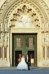 Image showing Bride and groom standing in front of Cathedral