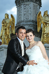 Image showing Bride and groom in front of fountain