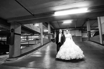 Image showing Newlyweds standing in garage bw