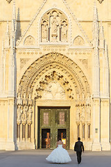 Image showing Newlyweds walking toward Cathedral