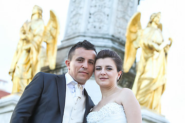 Image showing Newlyweds posing in front of fountain