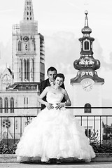 Image showing Bride and groom posing in city bw