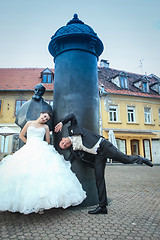 Image showing Newlyweds goofing in front of August Senoa Monument