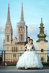 Image showing Bride and groom in front of cathedral