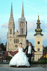 Image showing Bride and groom posing in front of church