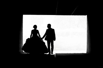 Image showing Bride and groom walking in passage bw