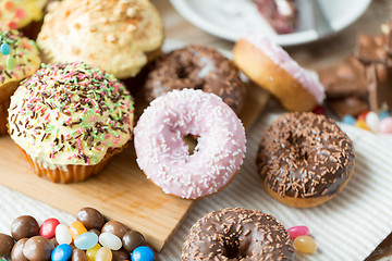 Image showing close up of glazed donuts and sweets on table