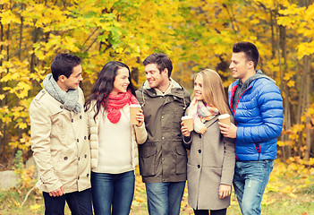 Image showing group of smiling friend with coffee cups in park