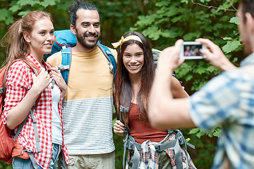 Image showing friends with backpack photographing by smartphone