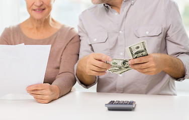 Image showing close up of senior couple with money and bills