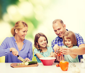 Image showing happy family with two kids making dinner at home