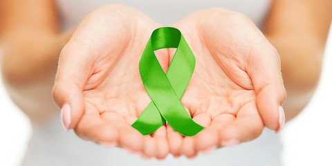 Image showing hands holding green awareness ribbon