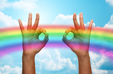 Image showing hands showing ok sign over rainbow background