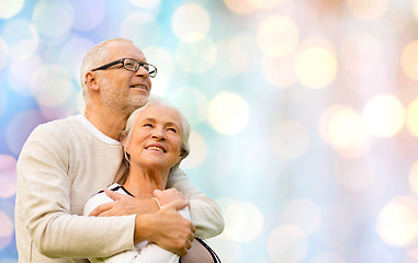 Image showing happy senior couple over holidays lights