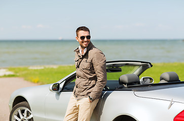 Image showing happy man near cabriolet car outdoors