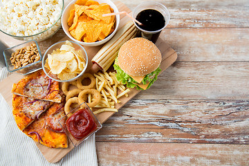 Image showing close up of fast food snacks and drink on table