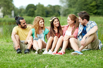 Image showing group of smiling friends talking outdoors