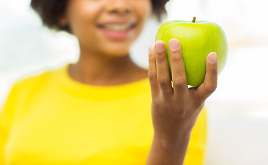 Image showing happy african american woman with green apple