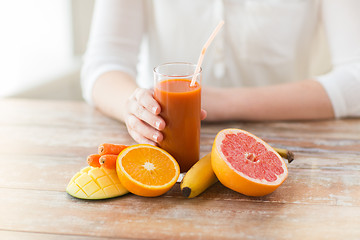 Image showing close up of woman hands with juice and fruits