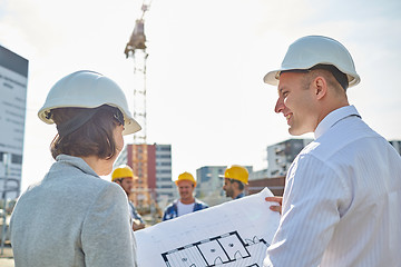 Image showing happy architects with blueprint at building