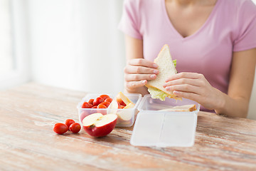 Image showing close up of woman with food in plastic container