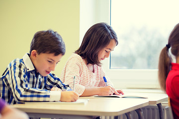 Image showing group of school kids writing test in classroom