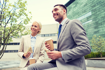 Image showing smiling businessmen with paper cups outdoors