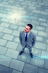 Image showing young smiling businessman outdoors from top