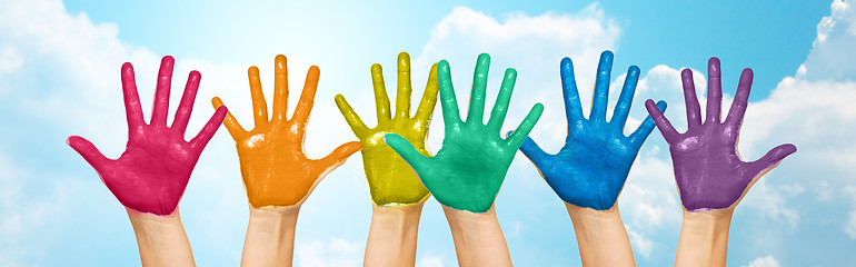 Image showing palms of human hands painted in rainbow colors