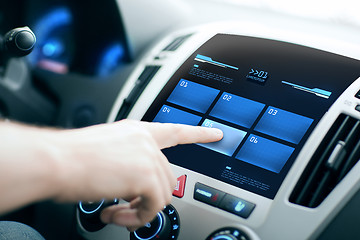 Image showing hand pushing button on car control panel screen