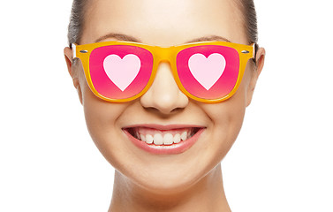 Image showing smiling teenage girl in pink sunglasses