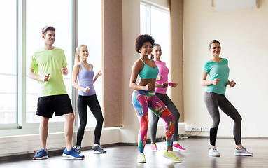 Image showing group of smiling people dancing in gym or studio