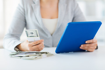 Image showing close up of woman hands with tablet pc and money