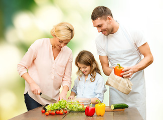 Image showing happy family cooking vegetable salad for dinner