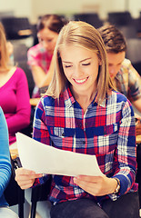 Image showing group of smiling students with notebook