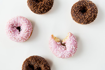 Image showing close up of glazed donuts pile over white