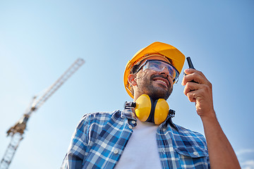 Image showing builder in hardhat with walkie talkie