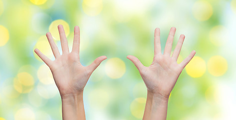 Image showing two woman hands making high five over blue sky
