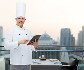 Image showing happy male chef cook holding tablet pc