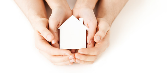 Image showing man and woman hands with white paper house