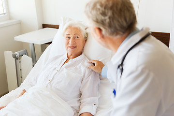 Image showing doctor visiting senior woman at hospital ward