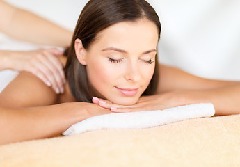 Image showing beautiful woman in spa salon getting massage