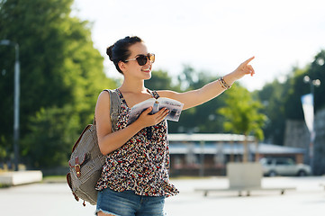 Image showing happy teenage girl with guidebook and backpack