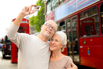Image showing senior couple photographing on london city street