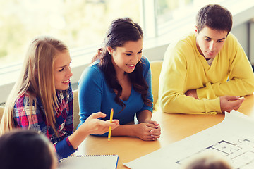 Image showing group of smiling students with blueprint